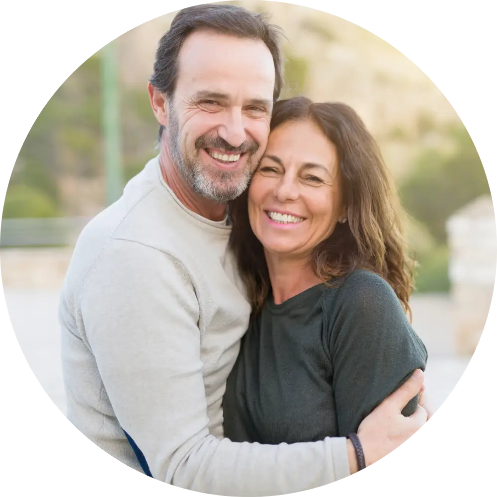 Middle-aged couples hugging and smiling at the camera